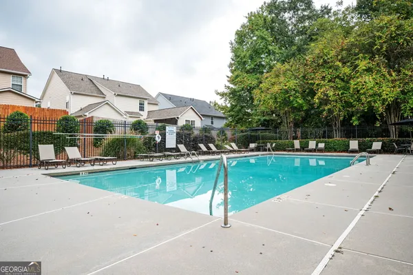 a swimming pool with outdoor seating yard and barbeque oven