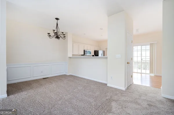 an empty room with windows and fireplace