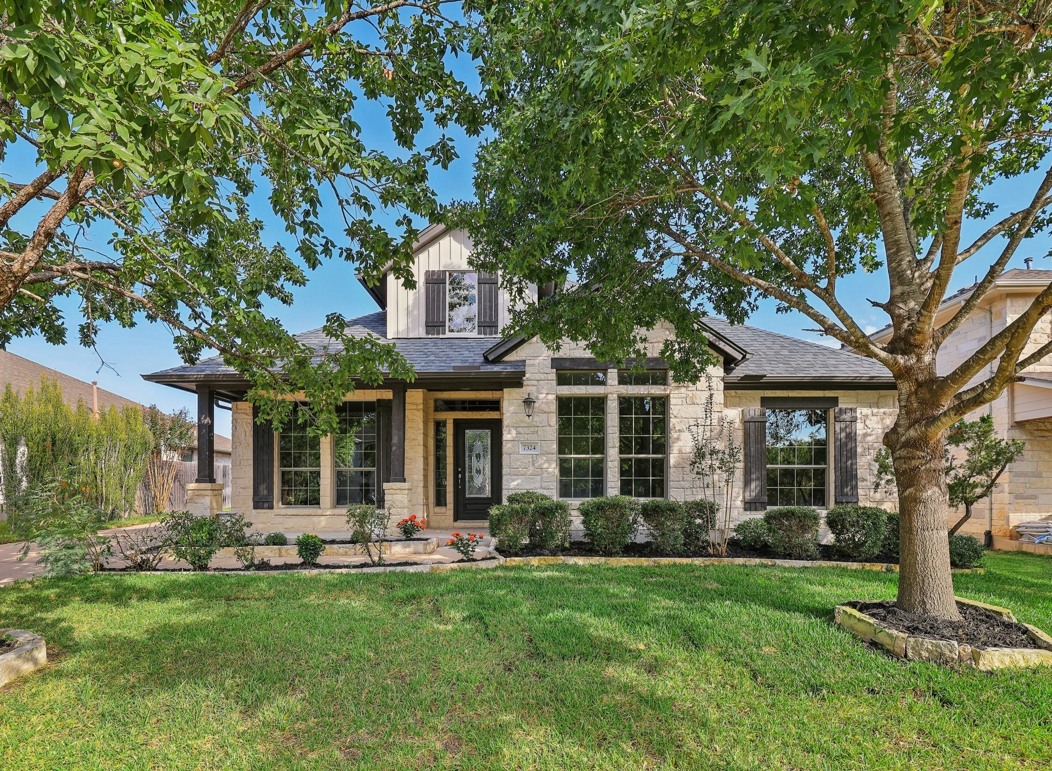 front view of a house with a tree in a yard