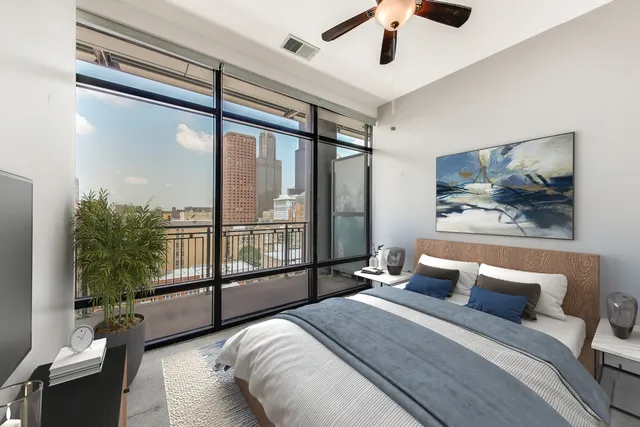 a bedroom with a large bed and a large window