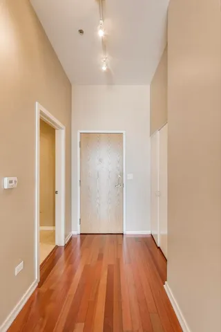 a view of hallway with wooden floor