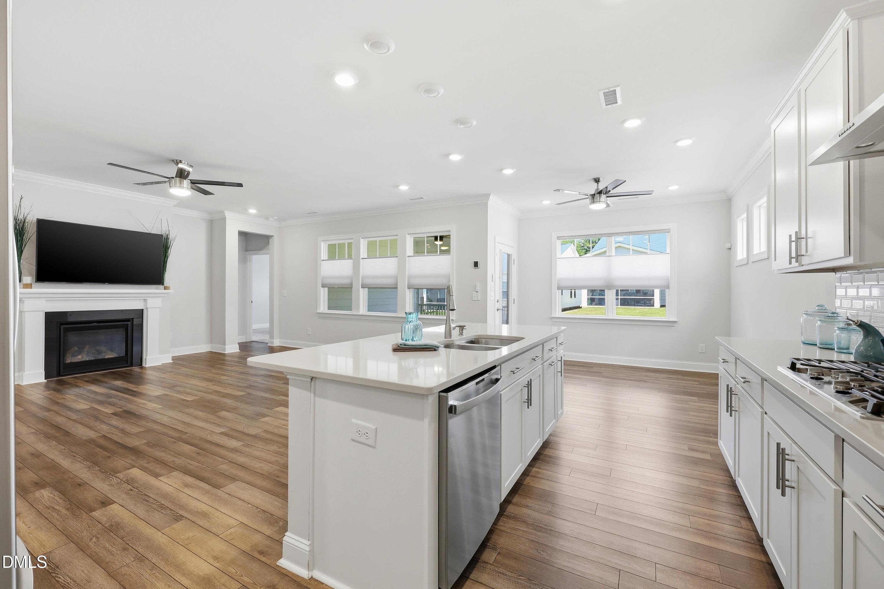 289 English Violet Lane Raleigh, NC 27610 - Photo 10 of 40 a kitchen with stainless steel appliances granite countertop a stove and a wooden floors