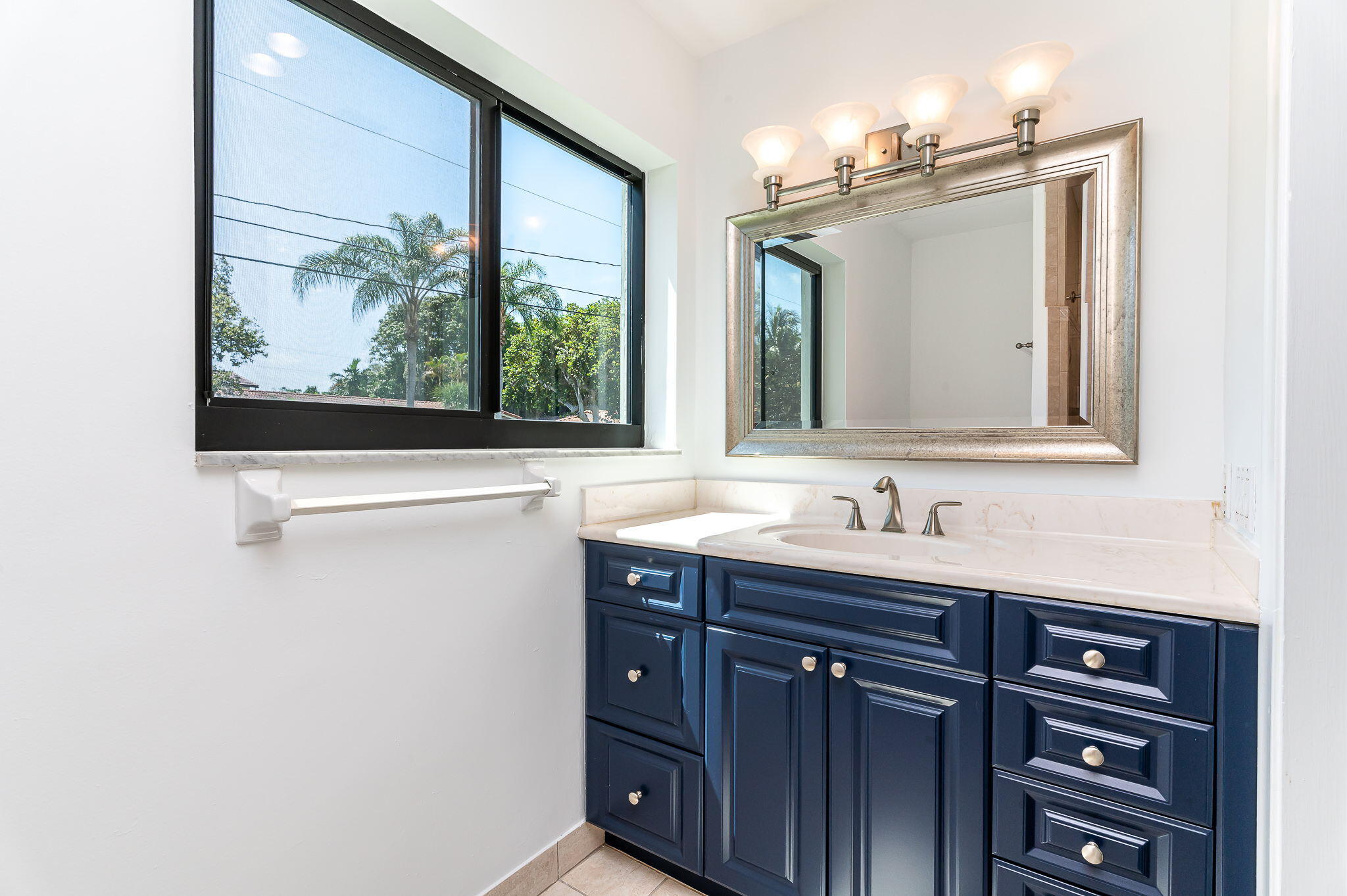 1151 Northwest 6th Avenue Boca Raton, FL 33432 - Photo 14 of 42 a bathroom with a granite countertop sink vanity and mirror