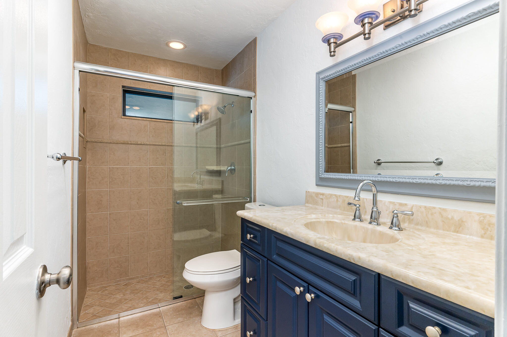 1151 Northwest 6th Avenue Boca Raton, FL 33432 - Photo 17 of 42 a bathroom with a granite countertop sink a toilet and shower