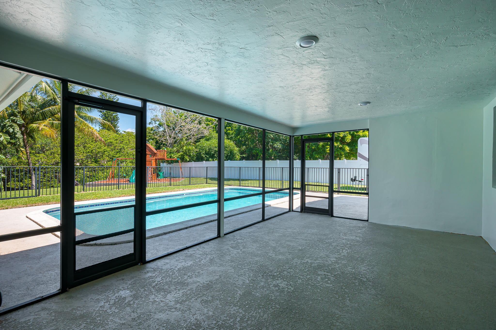 1151 Northwest 6th Avenue Boca Raton, FL 33432 - Photo 21 of 42 an empty room with sliding glass door
