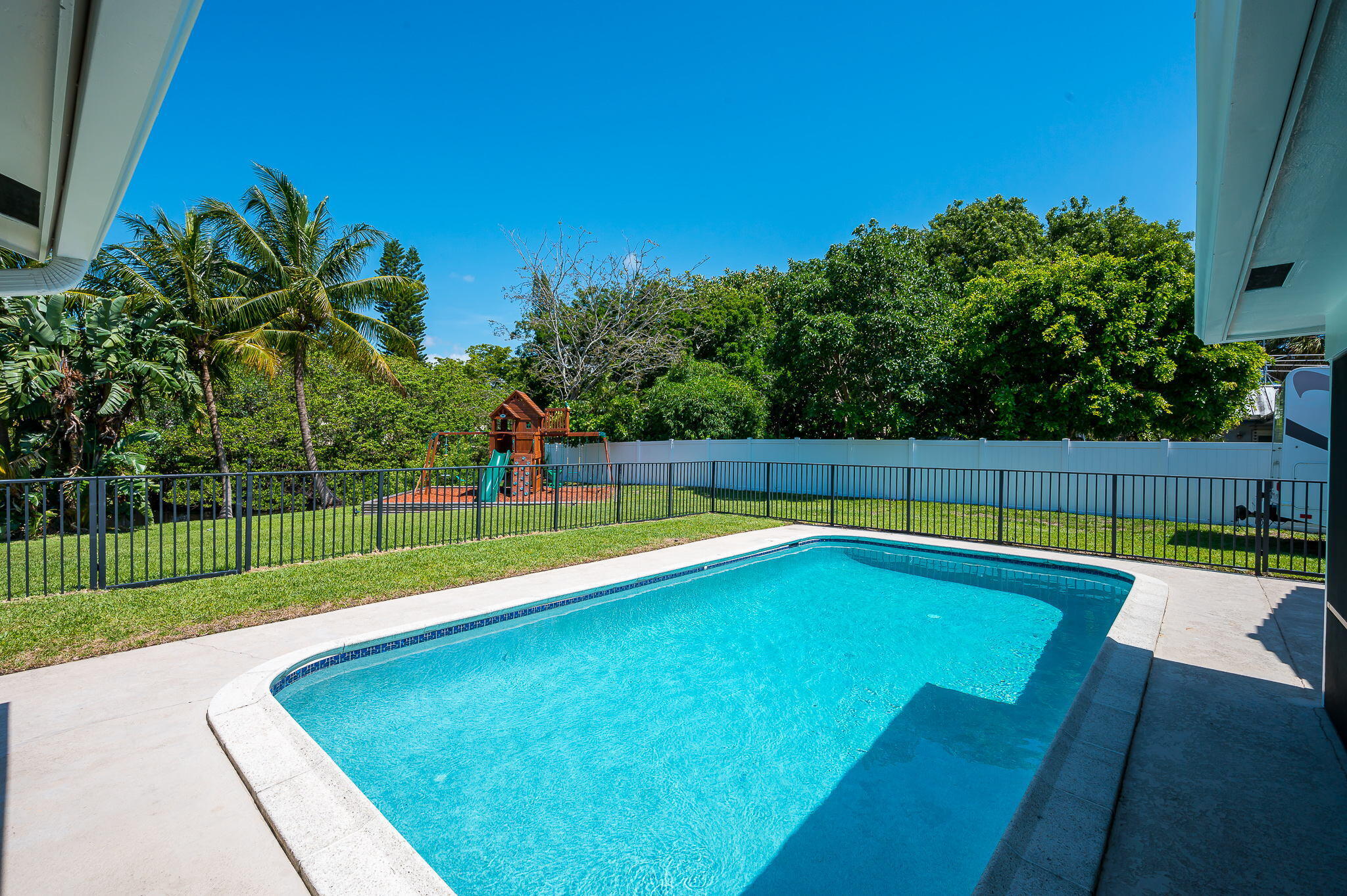 1151 Northwest 6th Avenue Boca Raton, FL 33432 - Photo 3 of 42 a view of swimming pool with a yard and trees