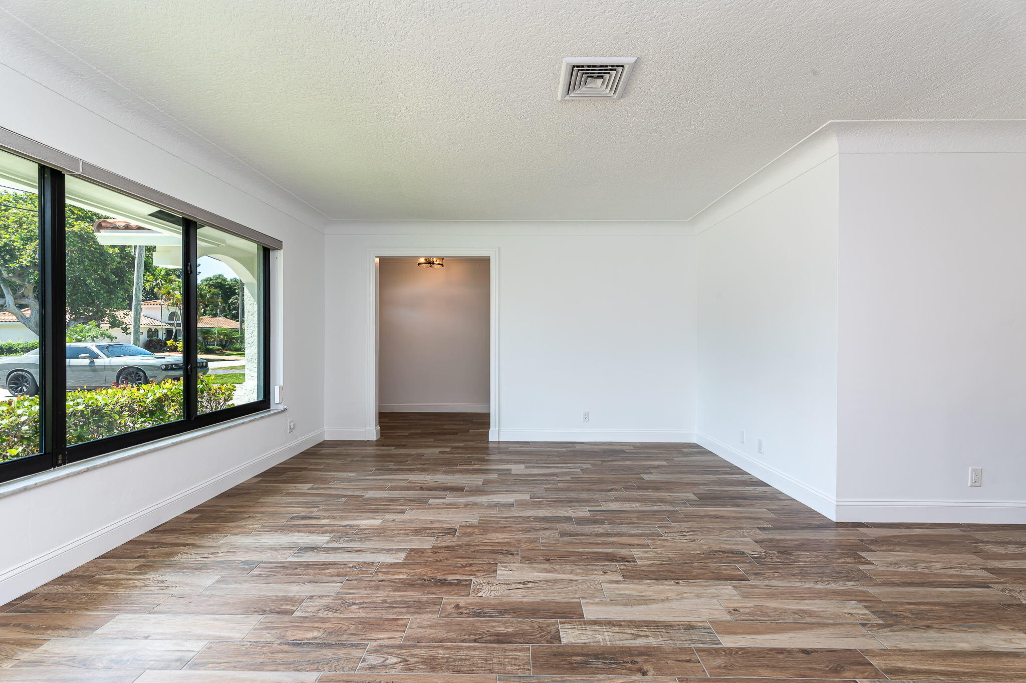 1151 Northwest 6th Avenue Boca Raton, FL 33432 - Photo 6 of 42 a view of empty room with wooden floor and fan