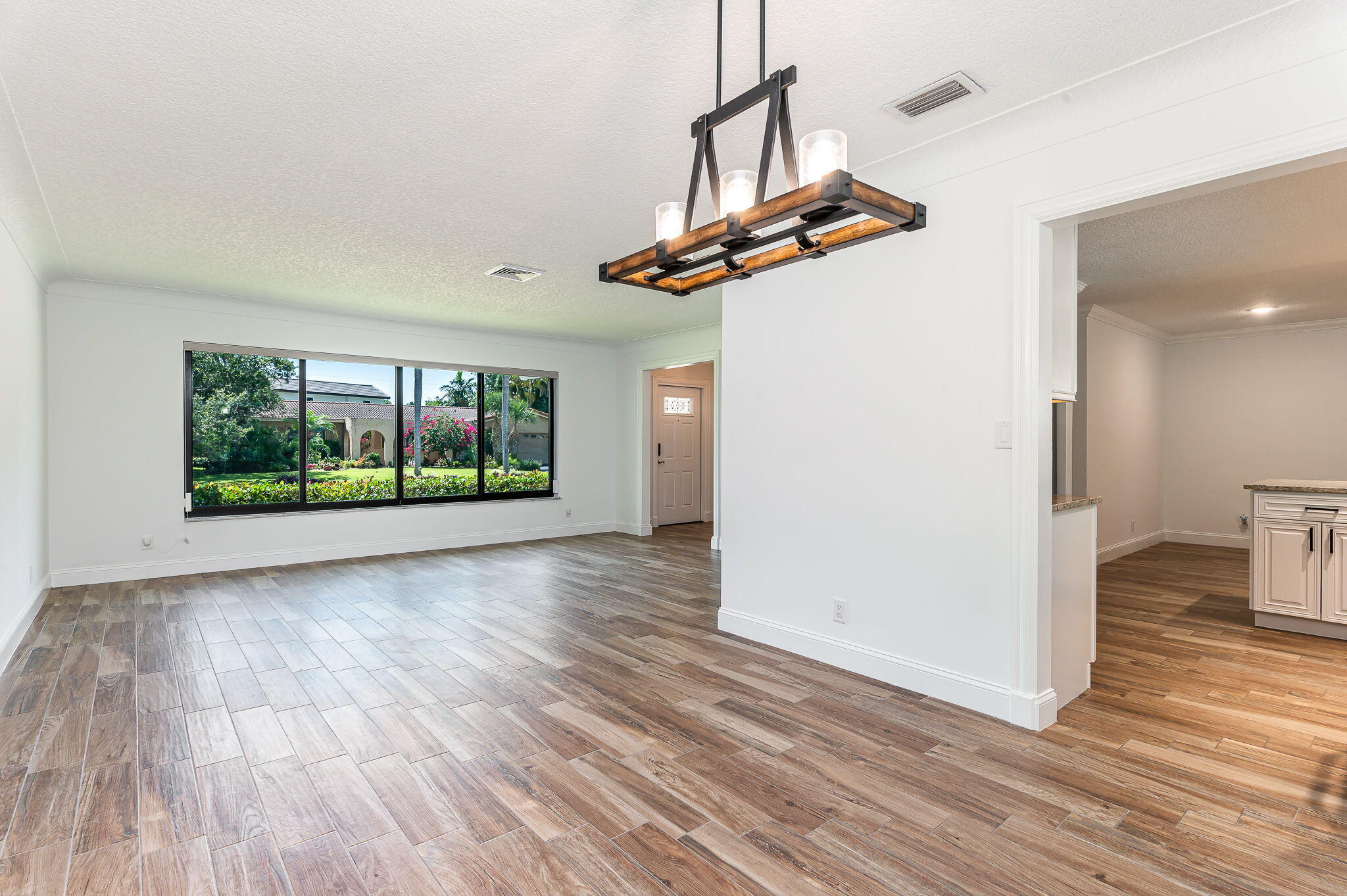 1151 Northwest 6th Avenue Boca Raton, FL 33432 - Photo 7 of 42 a view of a room with wooden floor and window