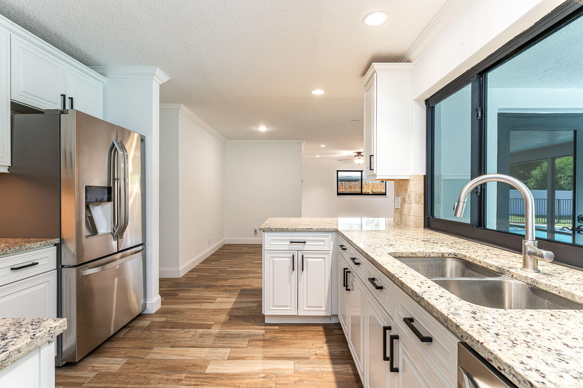 1151 Northwest 6th Avenue Boca Raton, FL 33432 - Photo 9 of 42 a kitchen with a sink stove and refrigerator