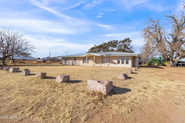 a living room with furniture a dining table and a window