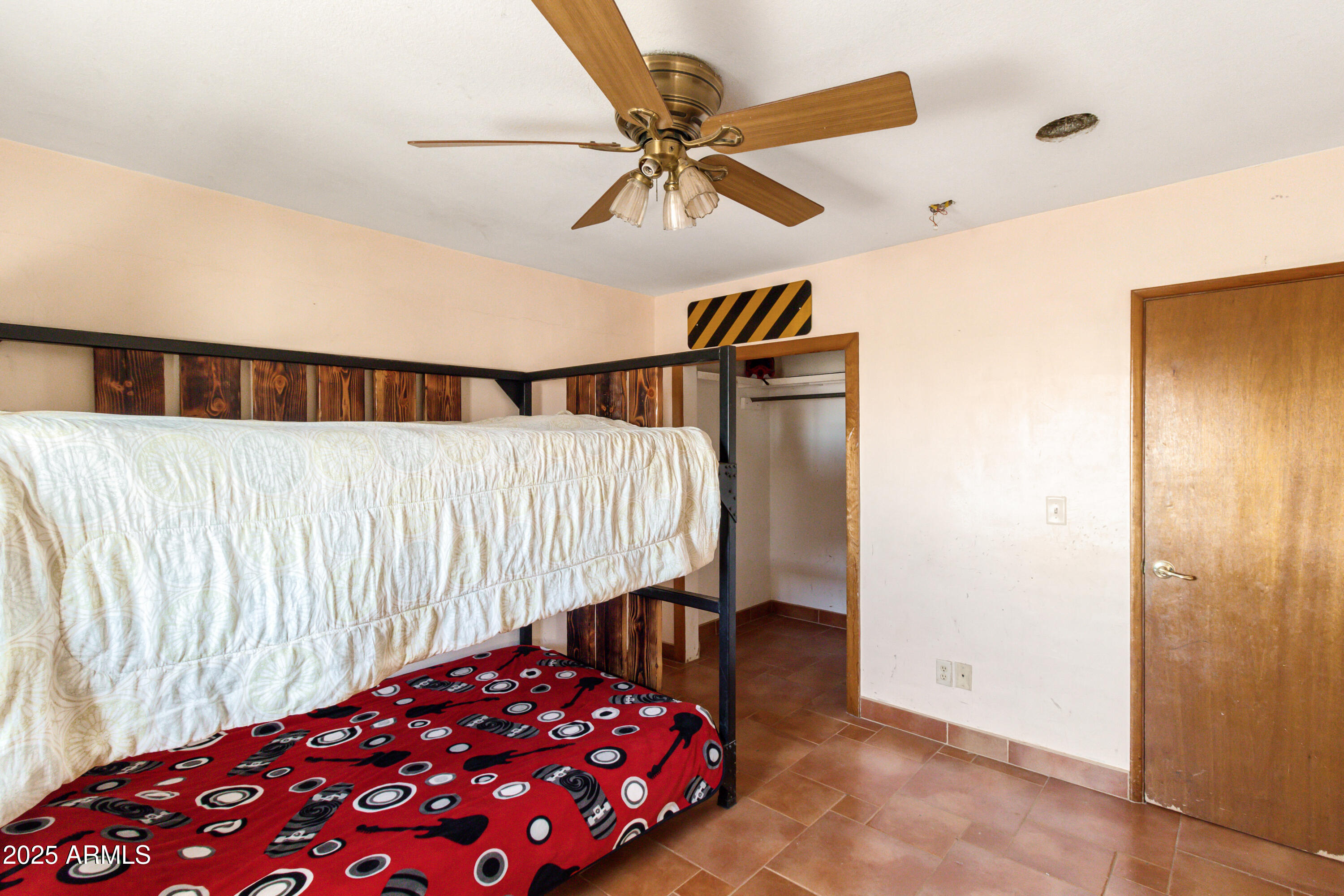 4842 West Gleeson Road Elfrida, AZ 85610 - Photo 36 of 51 a bedroom with a bed and a chandelier