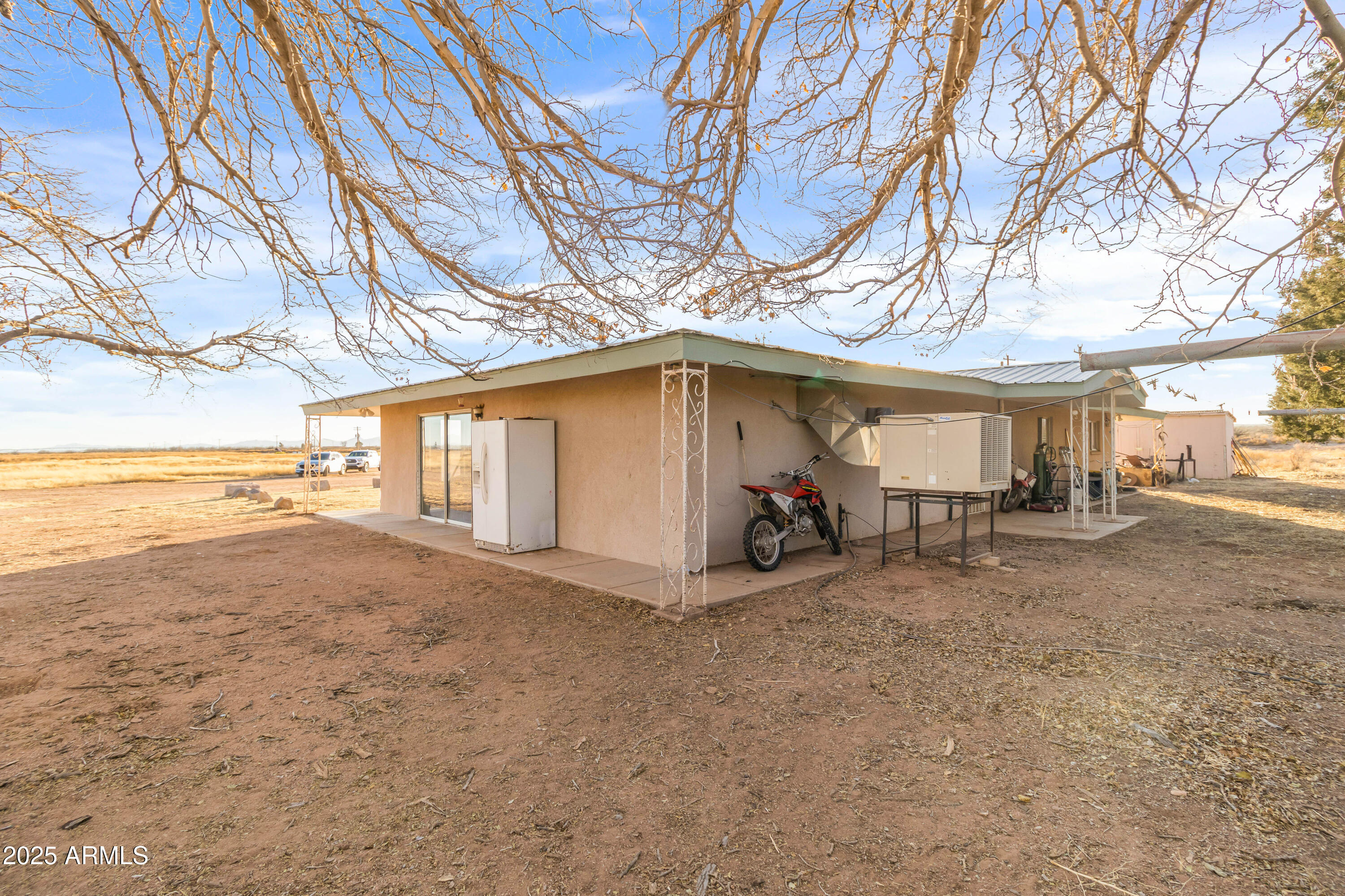 4842 West Gleeson Road Elfrida, AZ 85610 - Photo 45 of 51 a view of a house with a patio and a yard