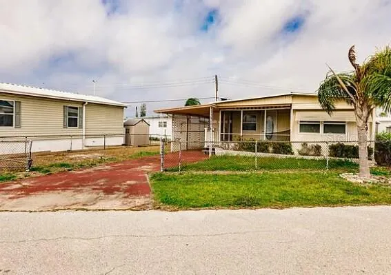 a front view of a house with a garden and plants