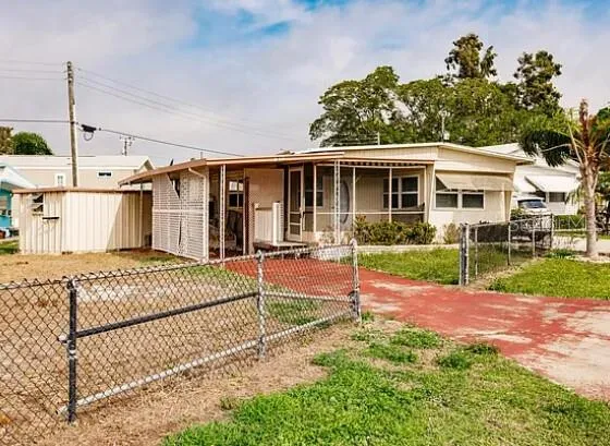a front view of a house with a garden and plants