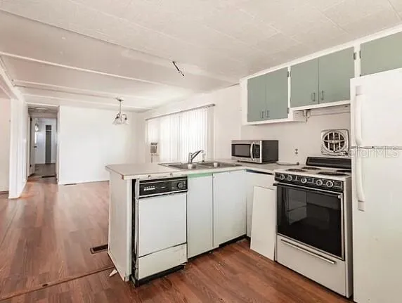 a kitchen with a stove and a refrigerator