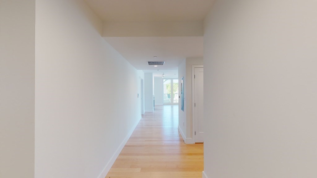 7 Beech Street, Unit 211 Cambridge, MA 02140 - Photo 5 of 7 a view of a hallway with wooden floor