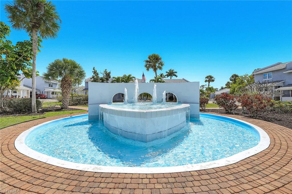 12 Watercolor Way, Unit 12 Naples, FL 34113 - Photo 2 of 35 a view of a small pool with plants