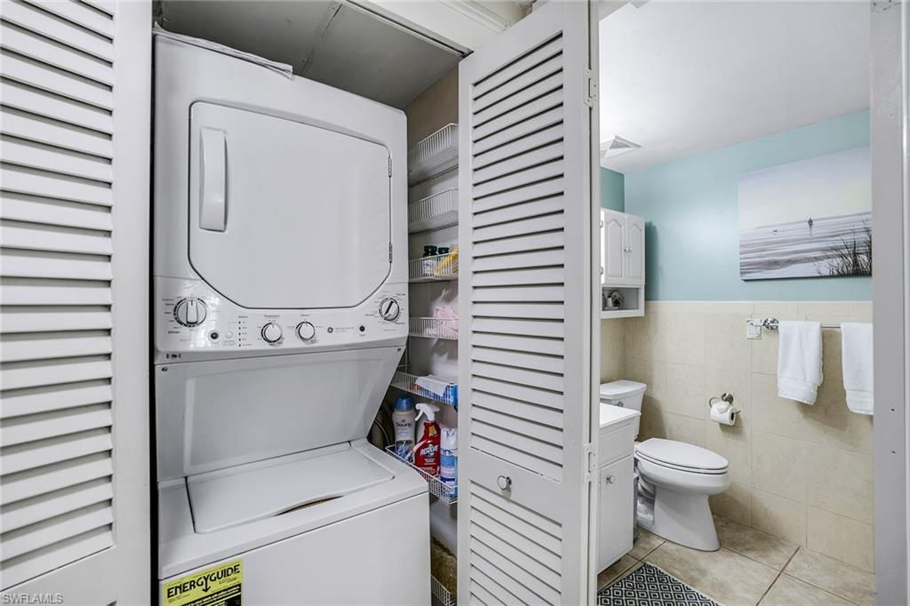 12 Watercolor Way, Unit 12 Naples, FL 34113 - Photo 28 of 35 a bathroom with a toilet a sink and a mirror