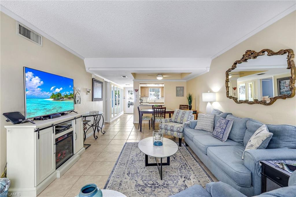 12 Watercolor Way, Unit 12 Naples, FL 34113 - Photo 5 of 35 a living room with furniture and a flat screen tv