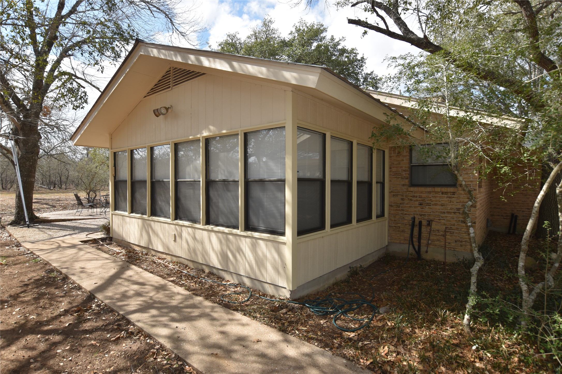 687 Fm 812 Road Red Rock, TX 78662 - Photo 17 of 40 View of home's exterior featuring a sunroom and brick siding