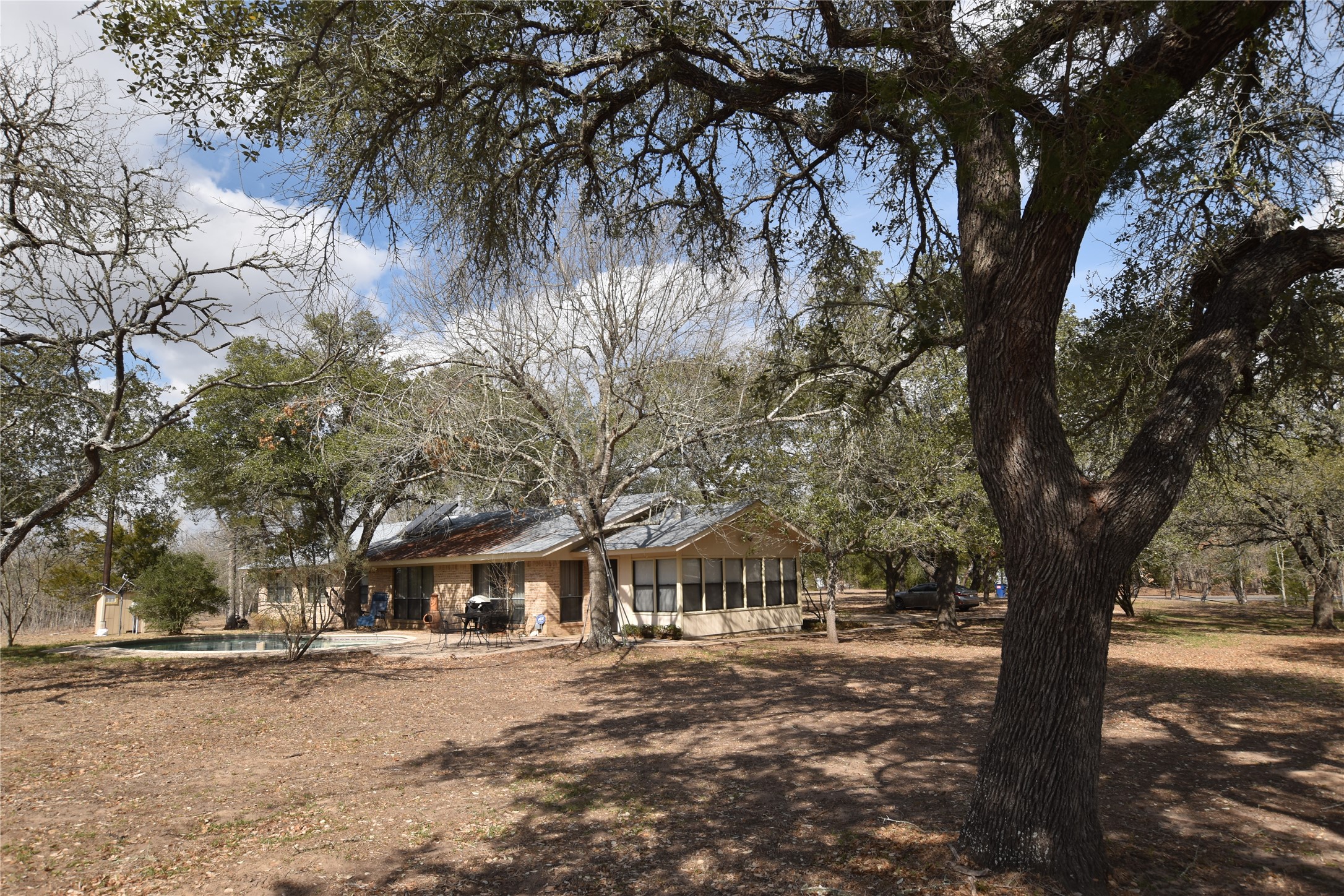 687 Fm 812 Road Red Rock, TX 78662 - Photo 23 of 40 View of front of home featuring a sunroom and an outdoor pool