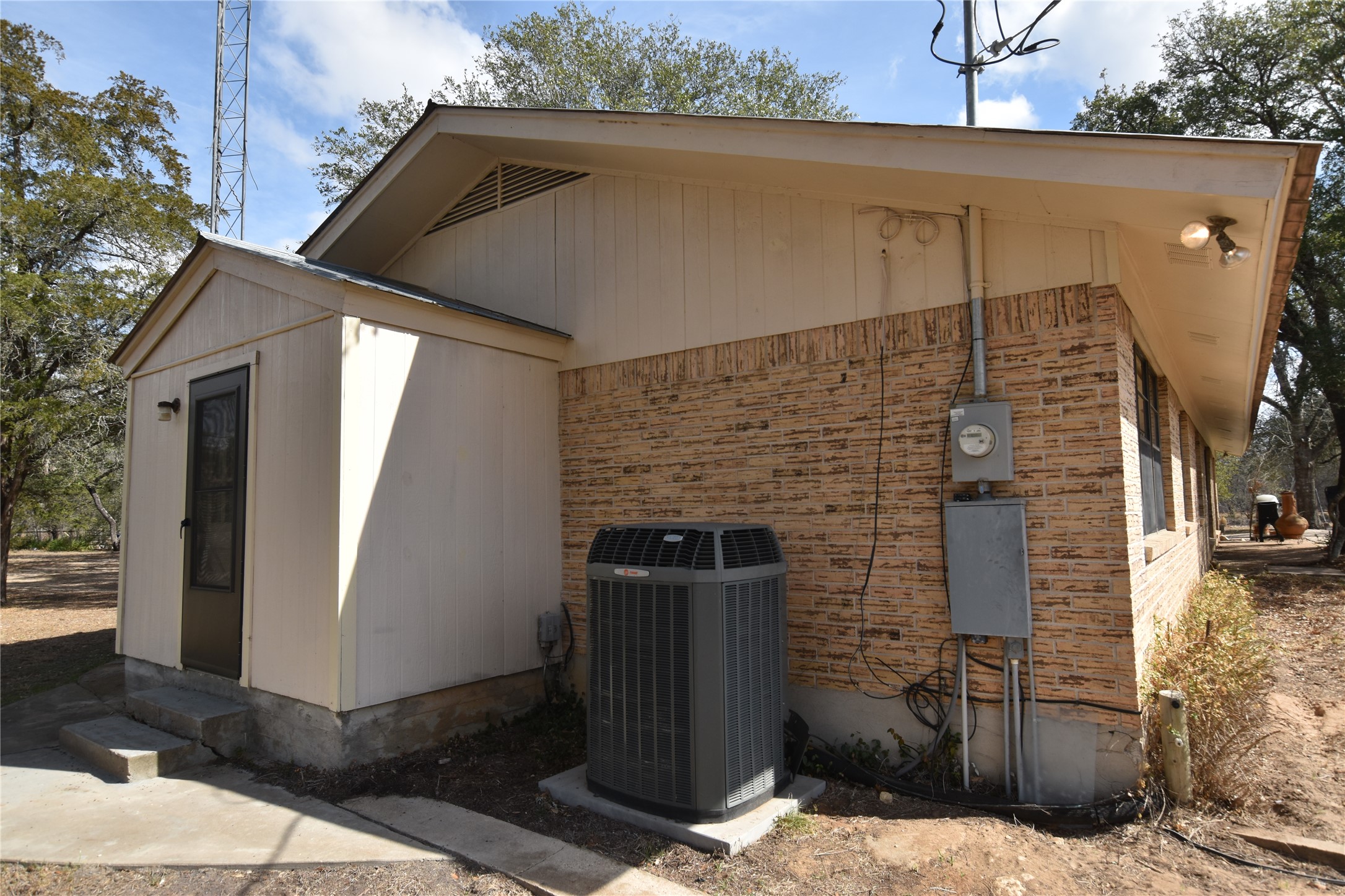 687 Fm 812 Road Red Rock, TX 78662 - Photo 26 of 40 View of side of property featuring brick siding and a central air condition unit