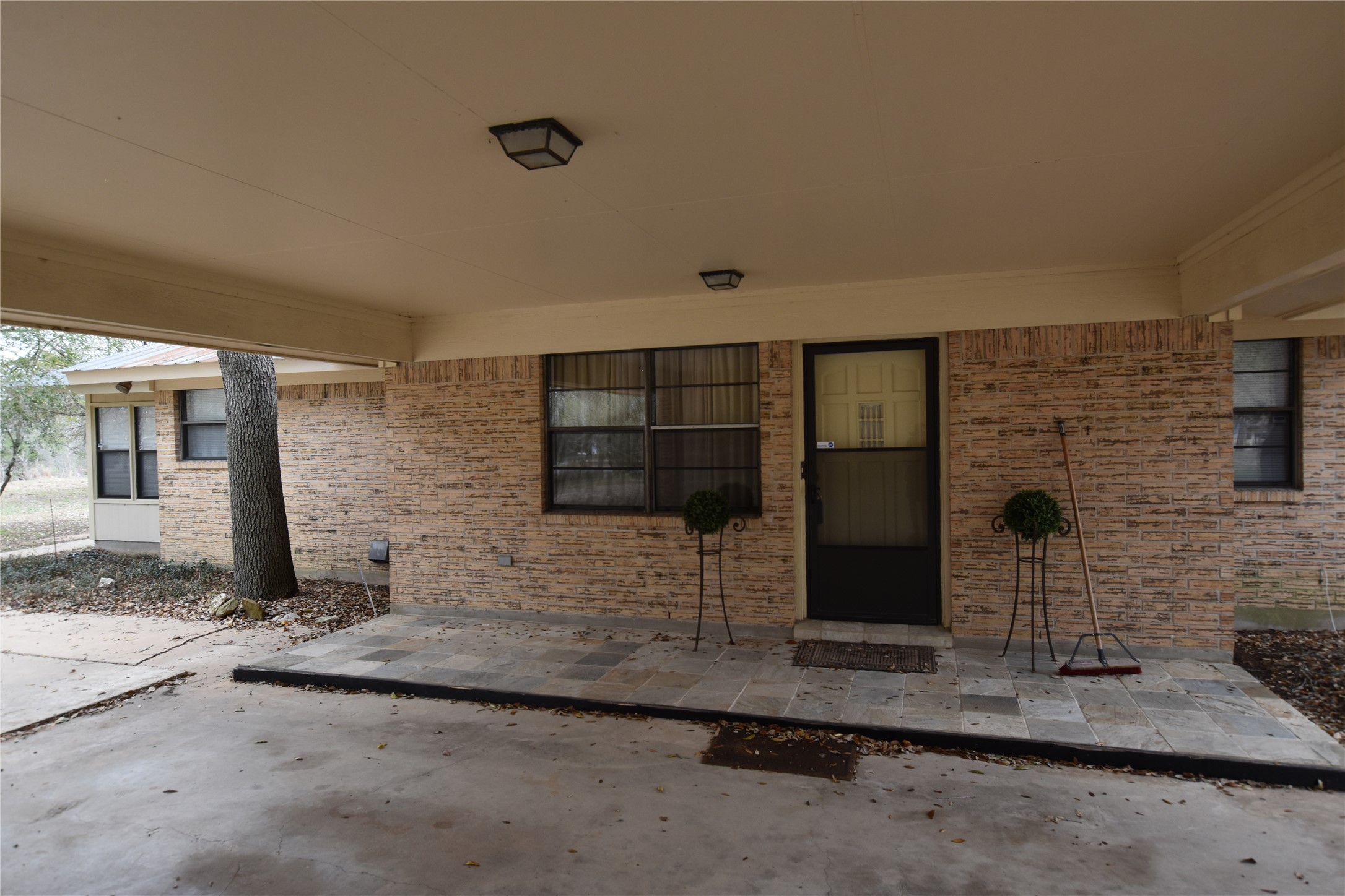 687 Fm 812 Road Red Rock, TX 78662 - Photo 4 of 40 Doorway to property featuring a patio area and brick siding
