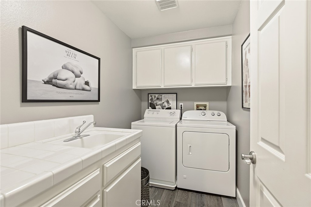 4762 Rhapsody Drive Oak Park, CA 91377 - Photo 18 of 29 a view of storage and utility room with washer and dryer