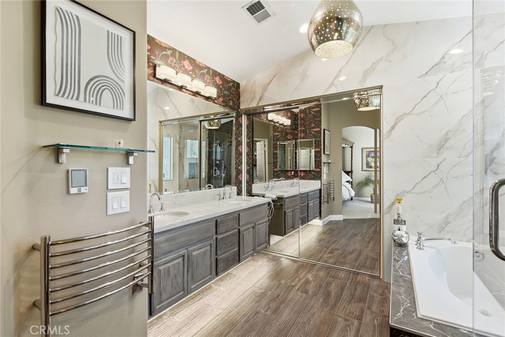4762 Rhapsody Drive Oak Park, CA 91377 - Photo 23 of 29 a bathroom with a sink a mirror and a bathtub