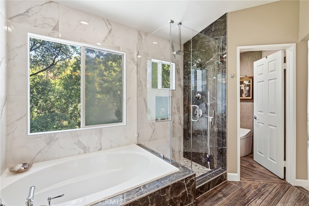 4762 Rhapsody Drive Oak Park, CA 91377 - Photo 24 of 29 a bathroom with a tub and a shower