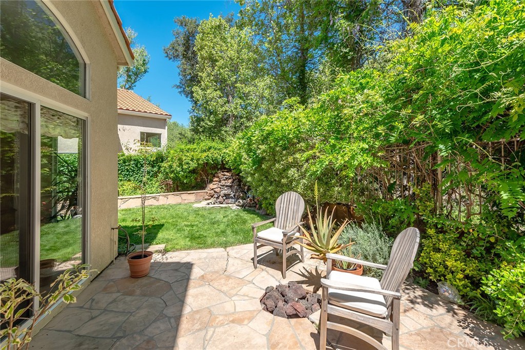 4762 Rhapsody Drive Oak Park, CA 91377 - Photo 28 of 29 a view of a patio with table and chairs and potted plants