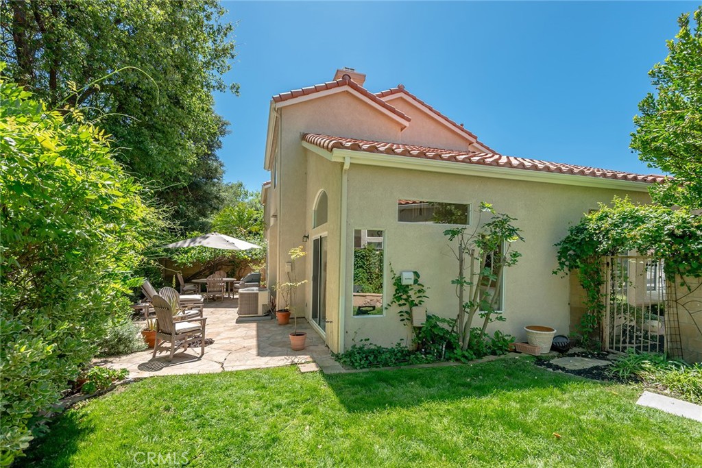 4762 Rhapsody Drive Oak Park, CA 91377 - Photo 4 of 29 a front view of a house with a yard