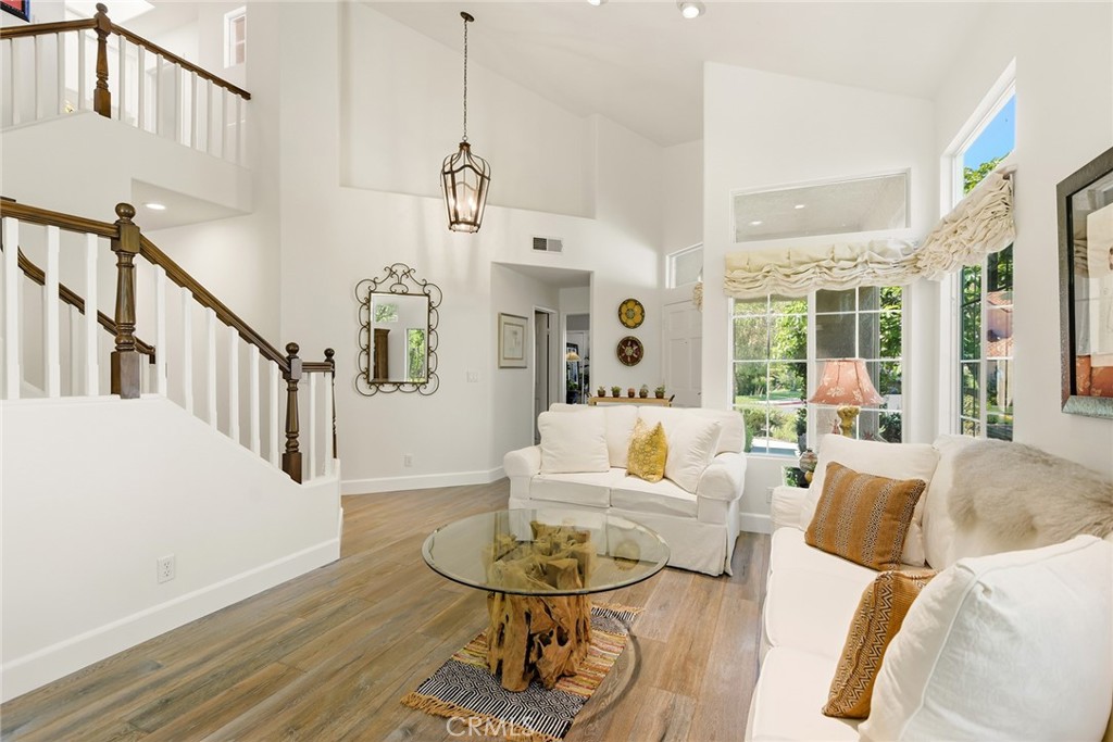 4762 Rhapsody Drive Oak Park, CA 91377 - Photo 9 of 29 a living room with fireplace furniture and a wooden floor
