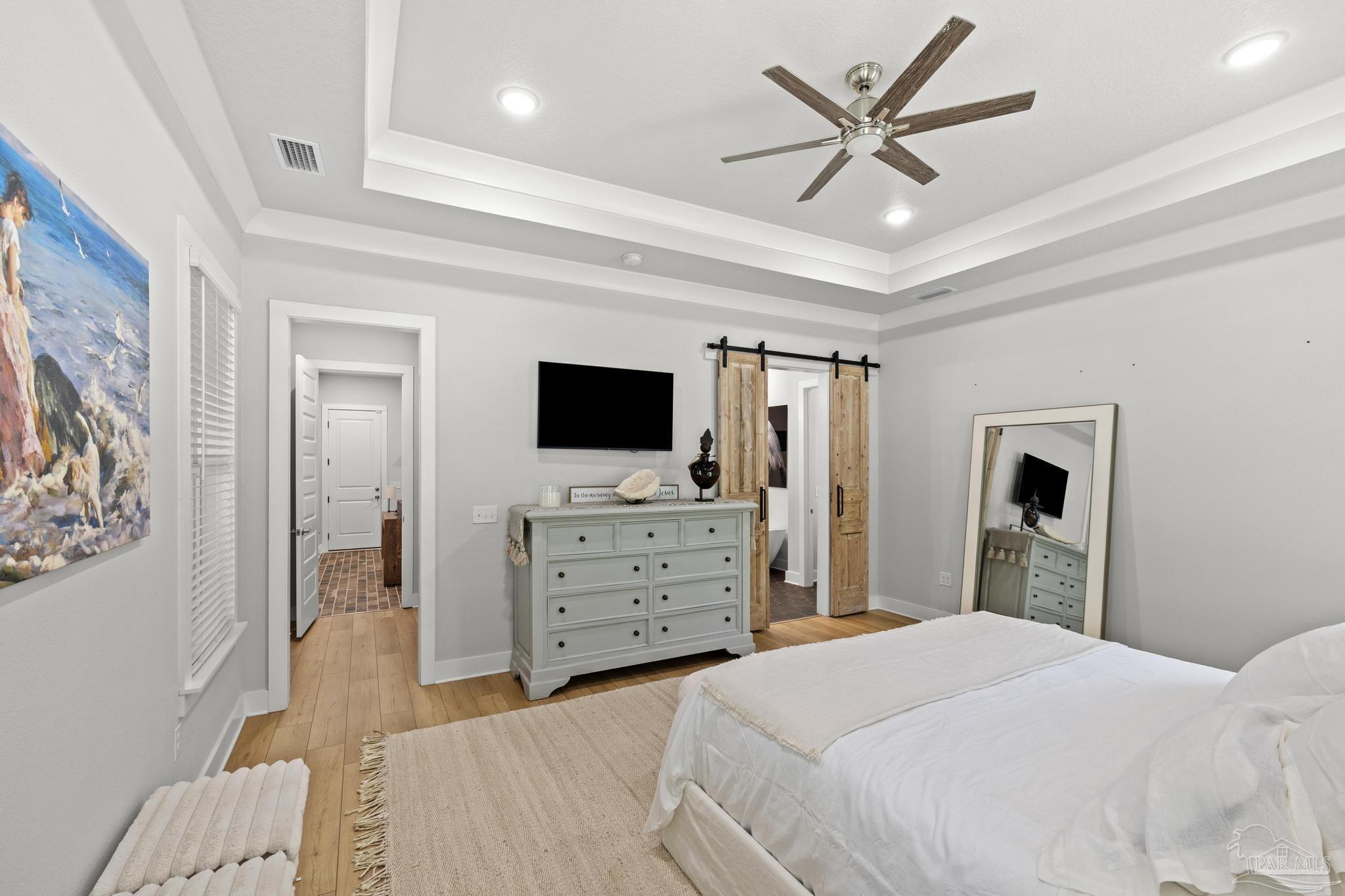 2031 Rambling Oaks Drive Cantonment, FL 32533 - Photo 28 of 62 a bedroom with a bed and a flat screen tv