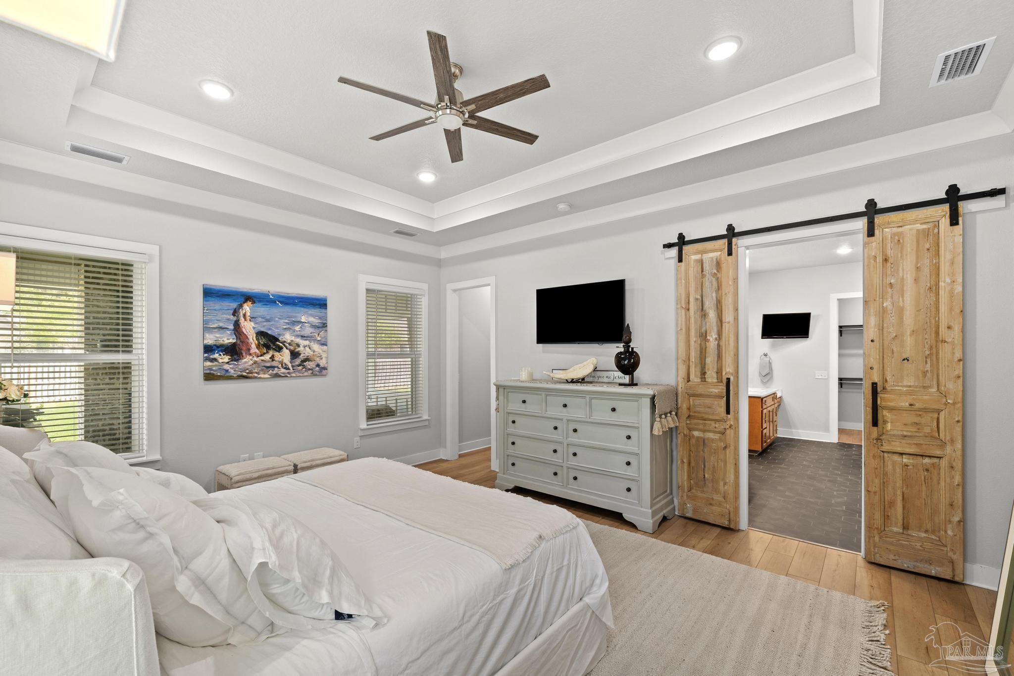 2031 Rambling Oaks Drive Cantonment, FL 32533 - Photo 29 of 62 a bedroom with a bed and a flat screen tv