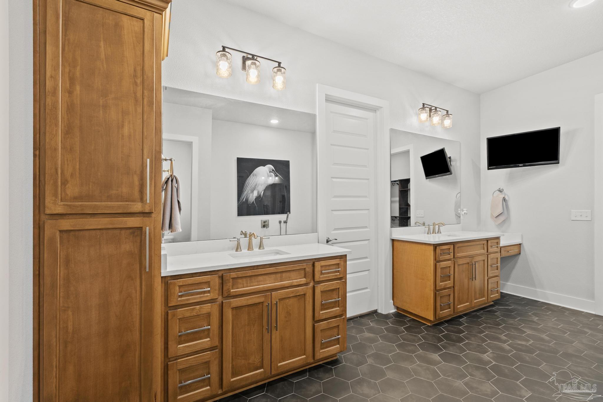 2031 Rambling Oaks Drive Cantonment, FL 32533 - Photo 31 of 62 a spacious bathroom with a double vanity sink and mirror