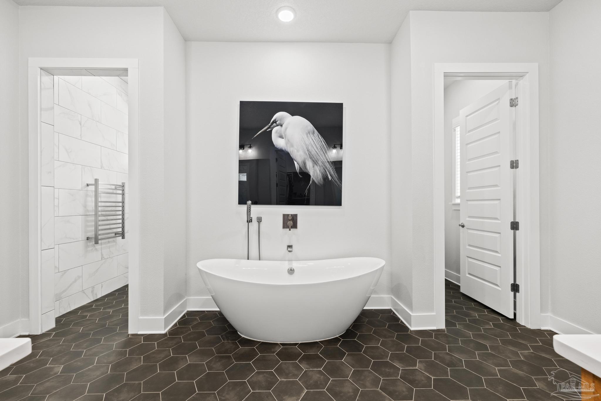 2031 Rambling Oaks Drive Cantonment, FL 32533 - Photo 32 of 62 a spacious bathroom with a bathtub and mirror