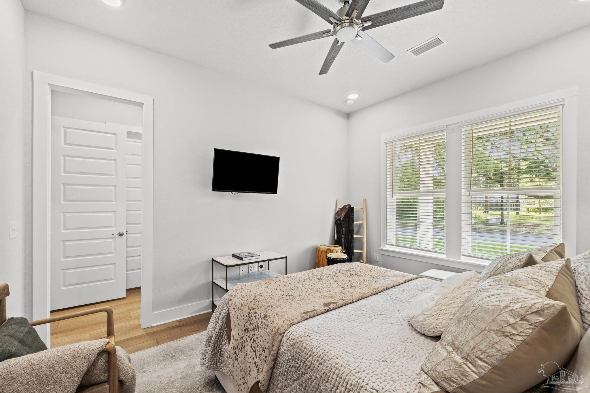 2031 Rambling Oaks Drive Cantonment, FL 32533 - Photo 38 of 62 a bedroom with a bed and a flat screen tv