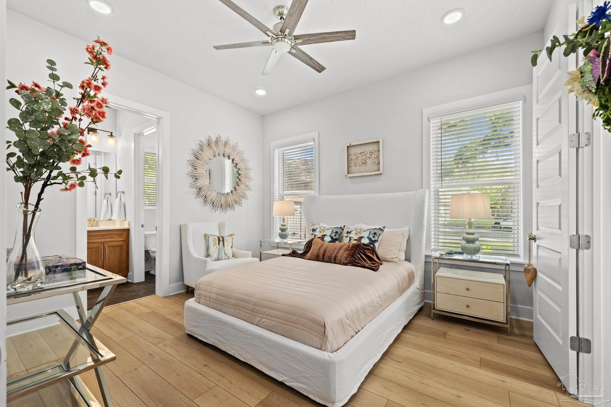 2031 Rambling Oaks Drive Cantonment, FL 32533 - Photo 42 of 62 a bedroom with a large bed and a chandelier