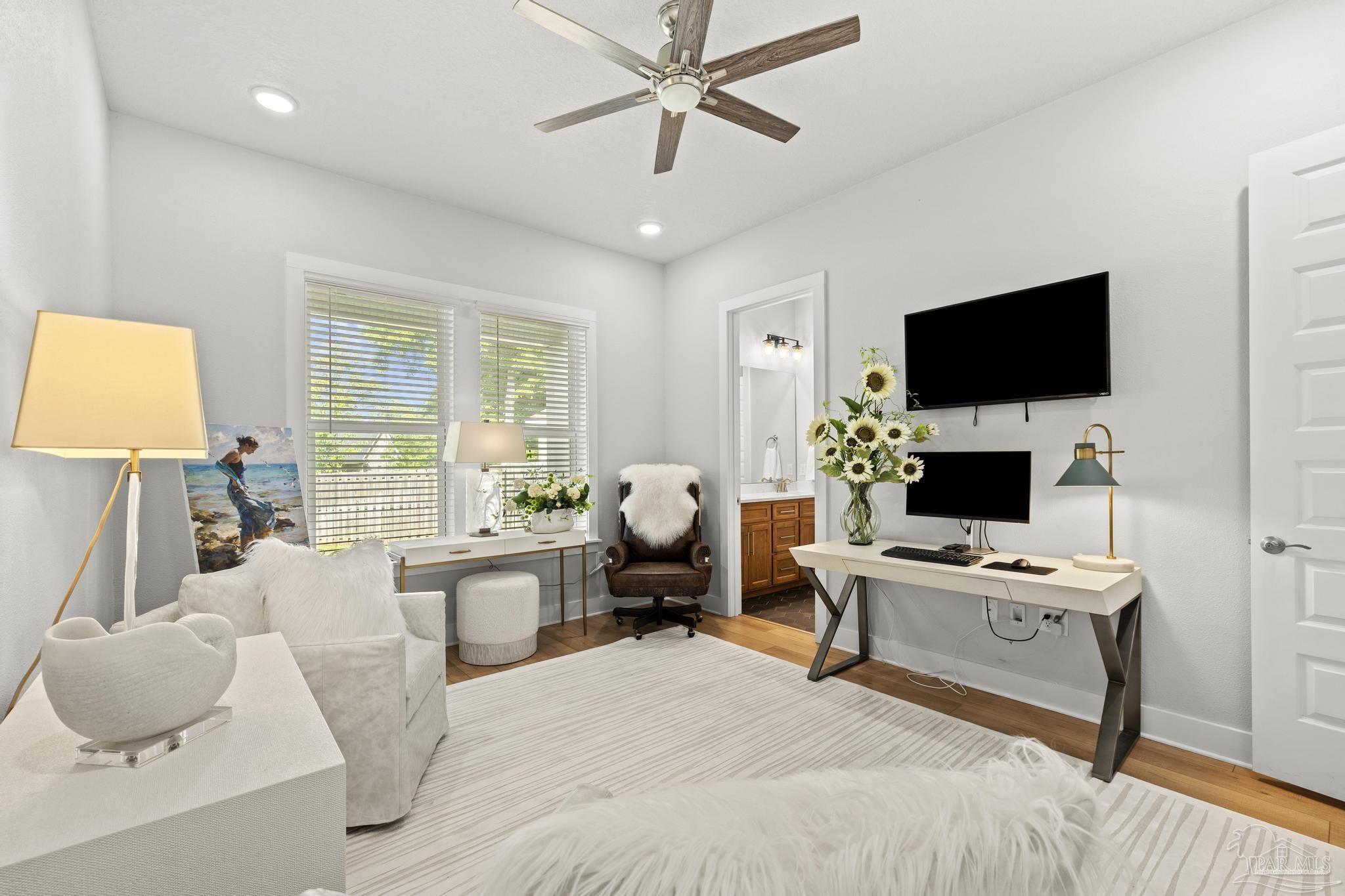 2031 Rambling Oaks Drive Cantonment, FL 32533 - Photo 47 of 62 a living room with furniture a fireplace and a flat screen tv