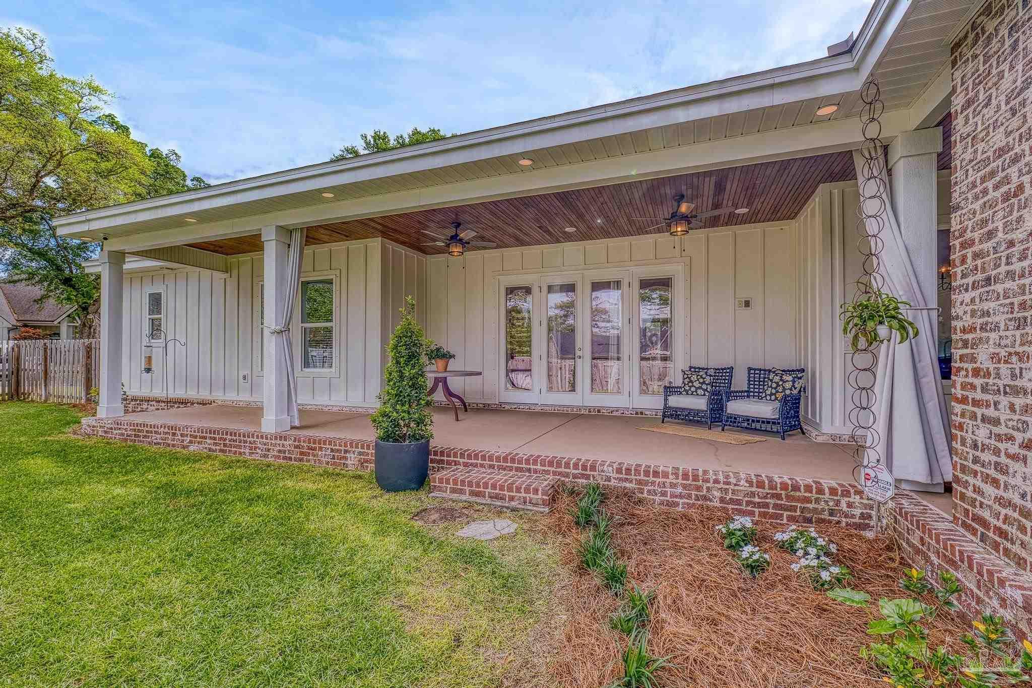 2031 Rambling Oaks Drive Cantonment, FL 32533 - Photo 54 of 62 a view of a house with backyard porch and sitting area