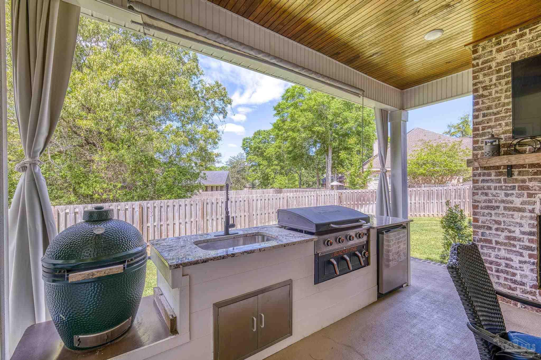 2031 Rambling Oaks Drive Cantonment, FL 32533 - Photo 57 of 62 a view of a patio with a table chairs and a barbeque