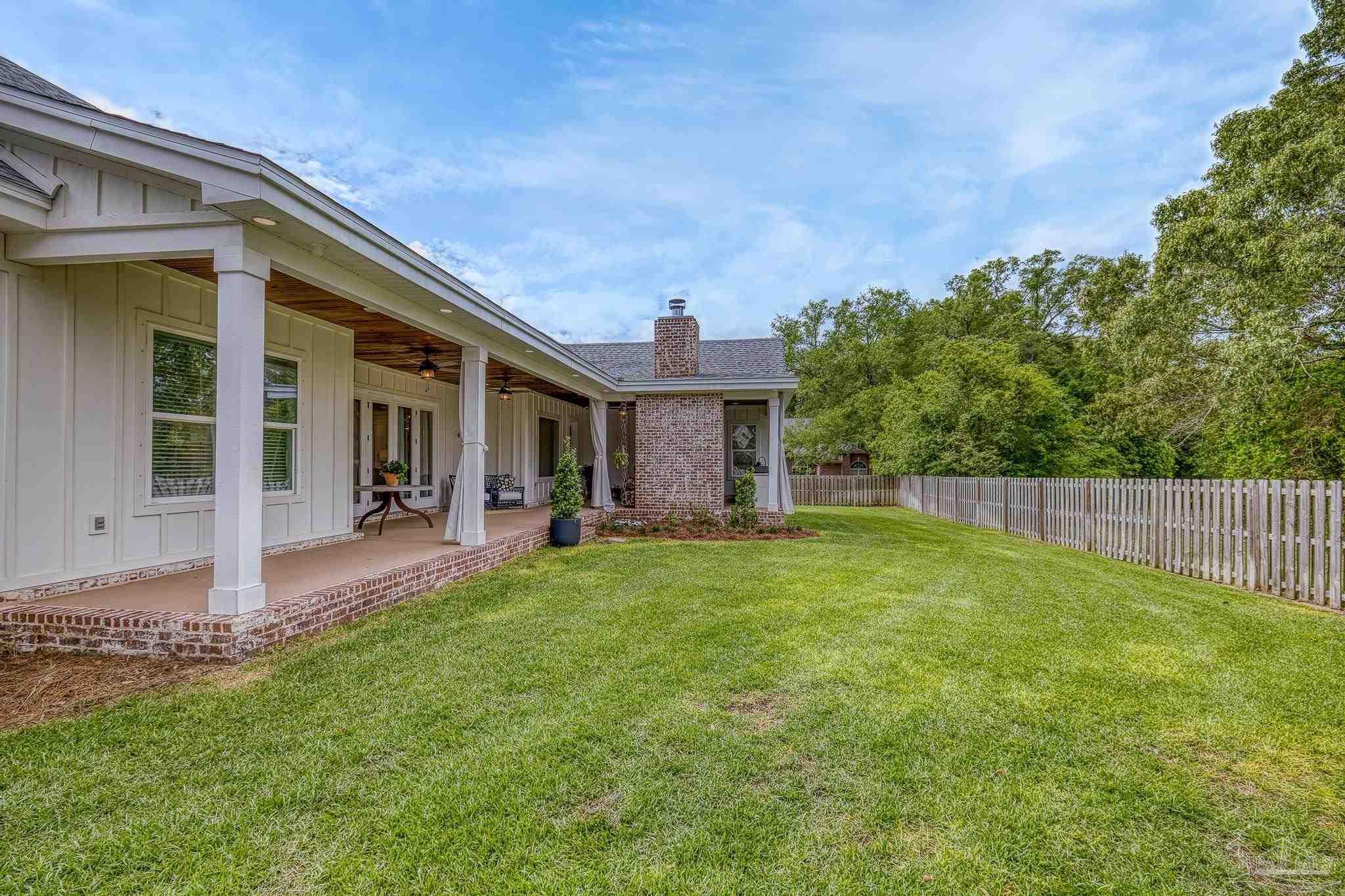 2031 Rambling Oaks Drive Cantonment, FL 32533 - Photo 59 of 62 a view of a house with a yard and sitting area