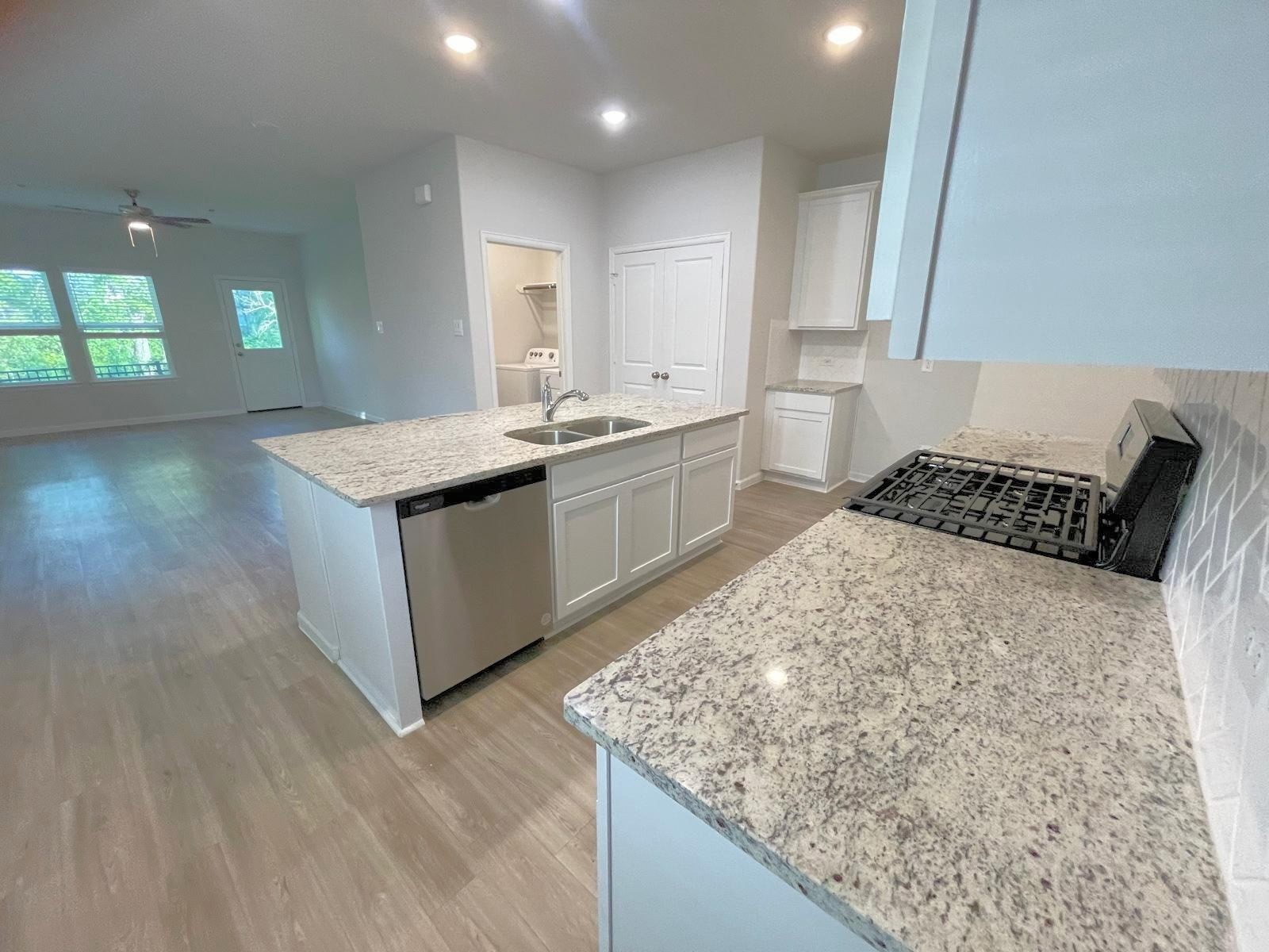 52 Valiant Ridge Trail Magnolia, TX 77354 - Photo 8 of 16 a kitchen with a sink stove and cabinets