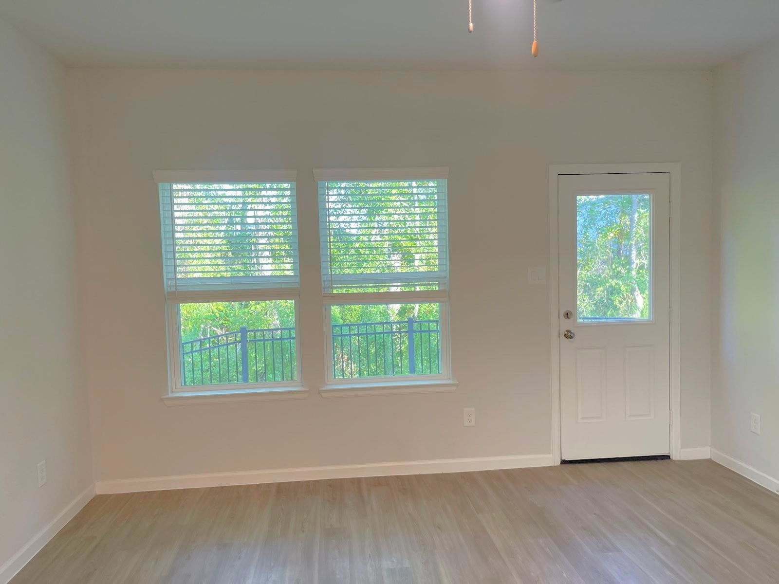 52 Valiant Ridge Trail Magnolia, TX 77354 - Photo 9 of 16 an empty room with wooden floor and windows