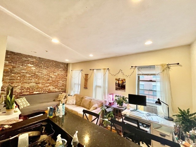 17 Thacher Street, Unit 3 Boston, MA 02113 - Photo 6 of 24 a living room with furniture flat screen tv and a large window
