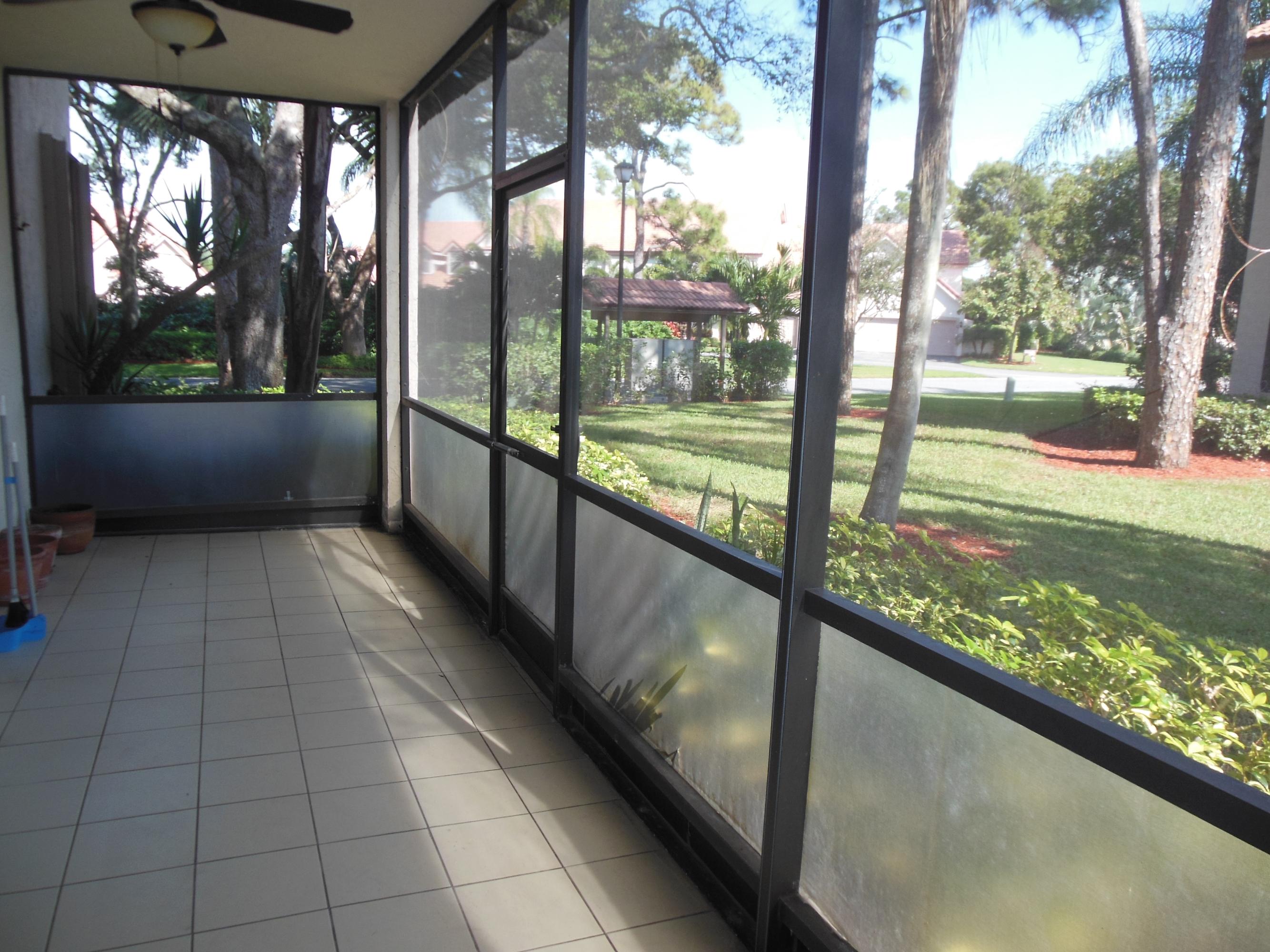 5780 Coach House Circle, Unit A Boca Raton, FL 33486 - Photo 20 of 37 Screened porch overlooking garden