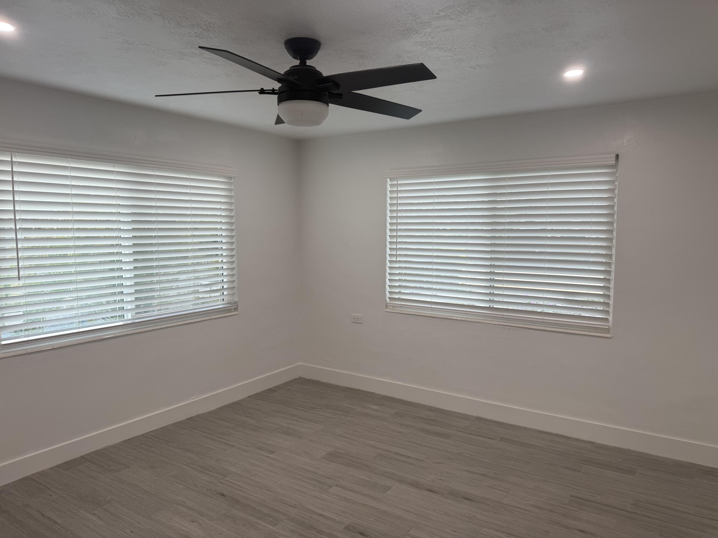 29656 Constitution Avenue Big Pine Key, FL 33043 - Photo 15 of 15 wooden floor in an empty room with a window