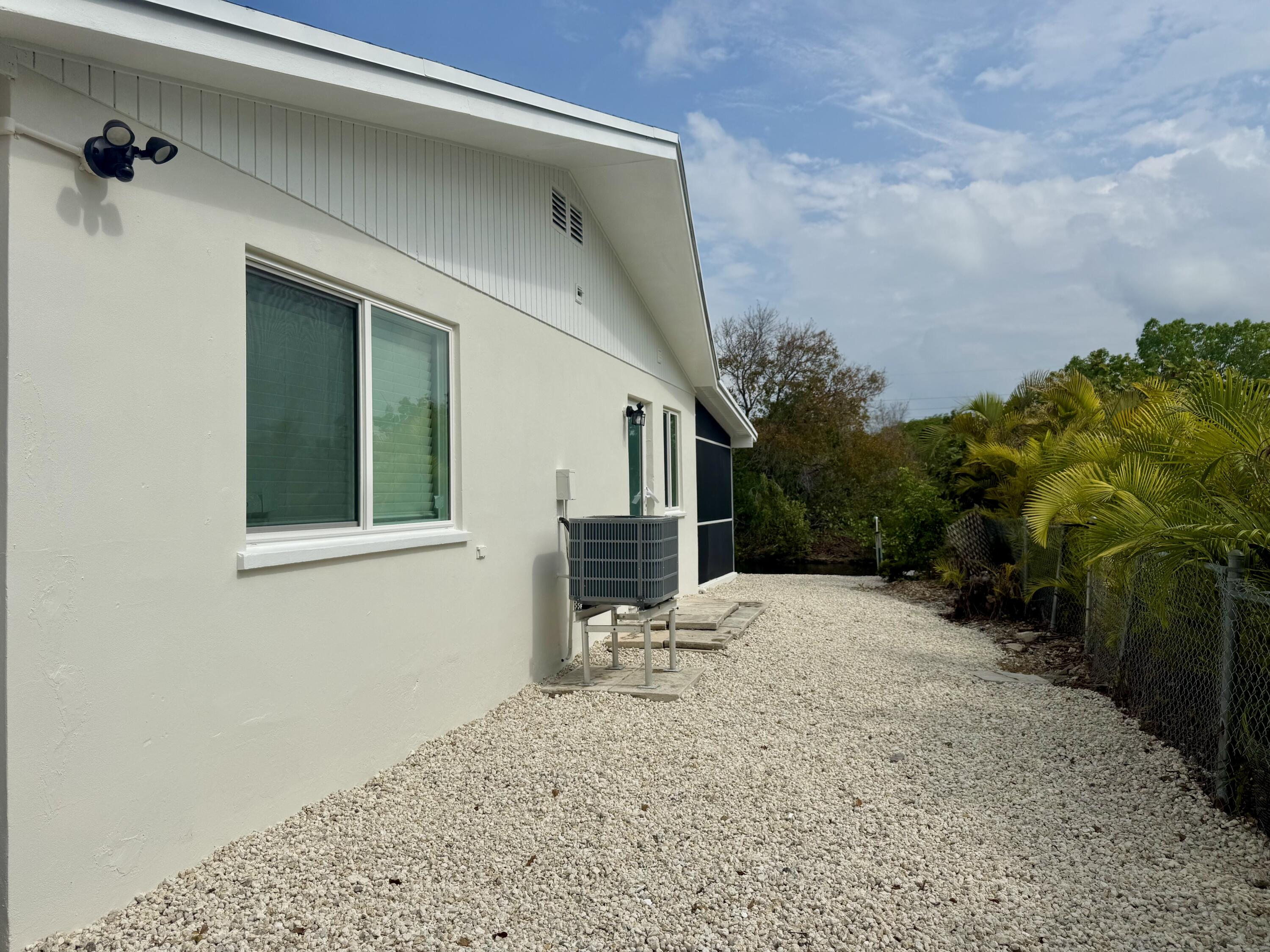 29656 Constitution Avenue Big Pine Key, FL 33043 - Photo 2 of 15 a view of a house with a yard and garage