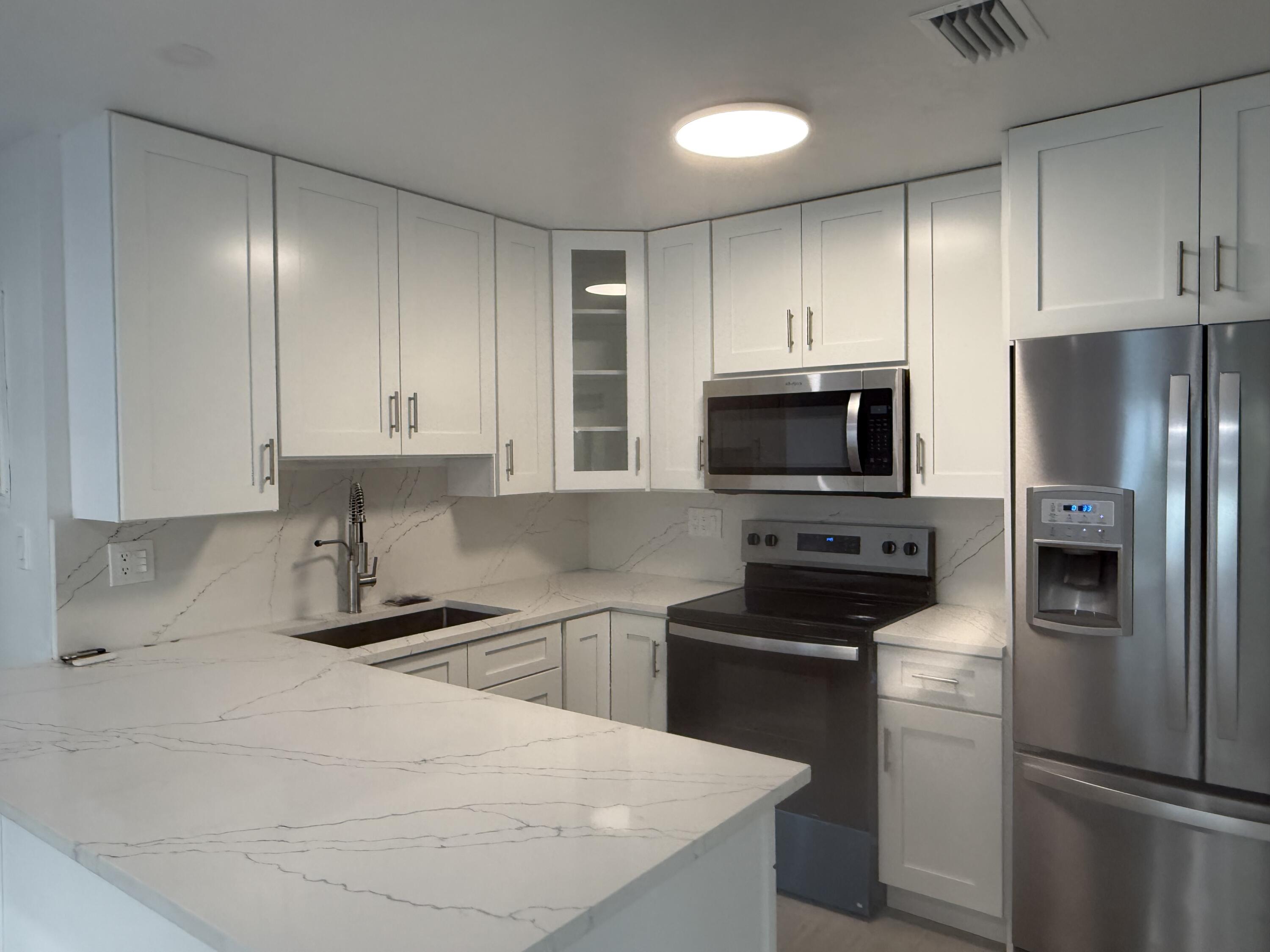 29656 Constitution Avenue Big Pine Key, FL 33043 - Photo 8 of 15 a kitchen with a refrigerator stove and microwave